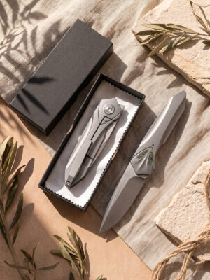 Premium titanium EDC folding knife with Takefu VG10 satin blade shown deployed and closed inside an elegant black gift box with cleaning cloth.