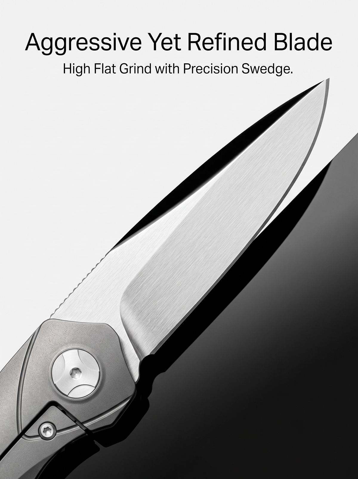 Close-up of VG10 satin drop-point blade featuring high flat grind, precision swedge, and rounded jimping on folding EDC pocket knife.